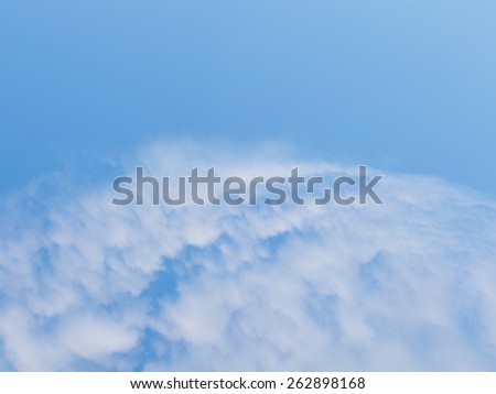 edge group of cumulus clouds against a bright blue sky