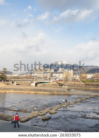 Kyoto - January 28, 2015: The recreation area in the fork of the river near KadziitÃ??, people relax and bridge of the large stones, Kyoto January 28, 2015 in Kyoto, Japan