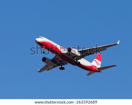 Domodedovo - March 17, 2015: Red and white passenger plane Tupolev Tu-204, Red Wings Airlines landing at Domodedovo airport March 17, 2015, Domodedovo, Moscow Region, Russia