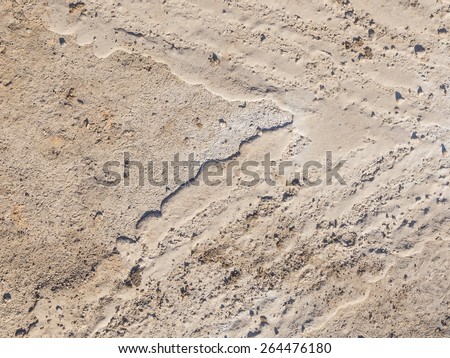 textured gray brown dirt on the ground on a country road