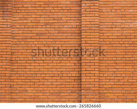 big red brick wall of brick facade with vertical ridges
