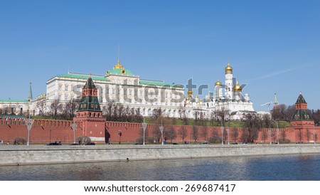 Moscow - April 12, 2015: Kremlin Embankment in early spring, people walking and cars go along the Kremlin walls and see the architectural ensemble of the Moscow Kremlin April 12, 2015, Moscow, Russia