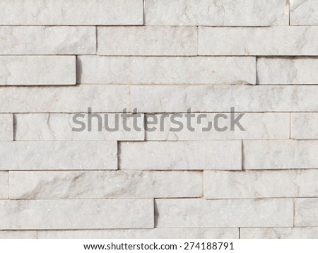 Wall of natural light shining white stone laid as a brick