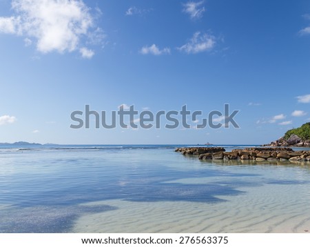 beautiful sea beach with big rocks and transparent sea salt water in good weather in the Seychelles