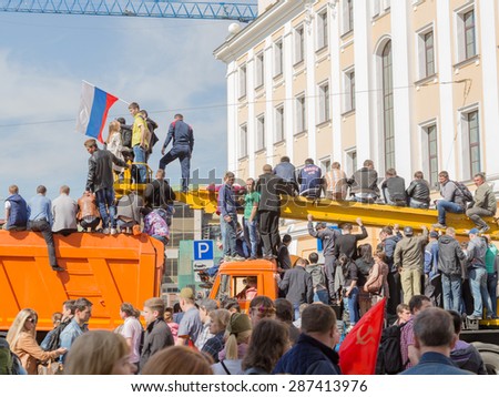 Moscow - May 9, 2015: People gathered and got on the car to see the parade on Victory Day and raised the flag of Russia in Moscow on May 9, 2015, Moscow, Russia