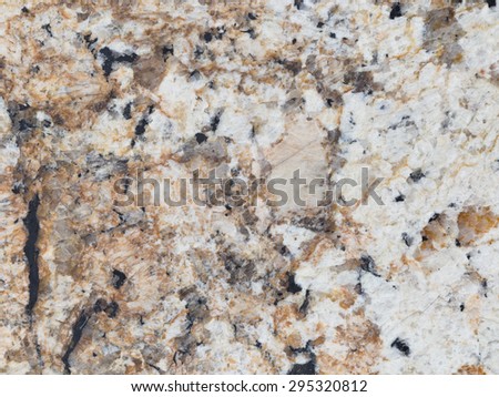 wall made of natural beige and gray granite stone with contrasting spots