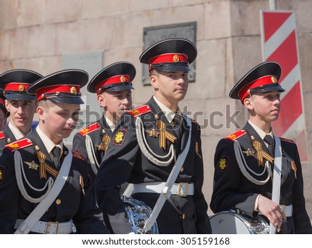 Moscow - May 7th, 2015: Young musicians in the beautiful St. George\'s uniform with ribbons and drums of a military band go after a rehearsal of the Victory Parade May 7, 2015, Moscow, Russia