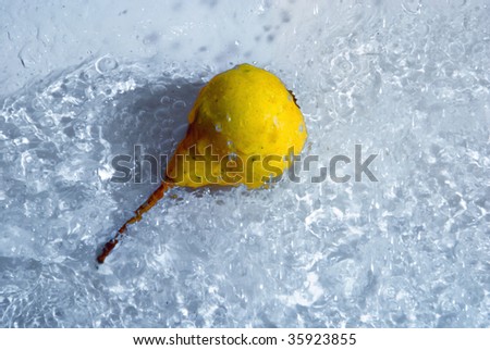 pear in the water in a blue yellow red water juicy big drops of relief beautiful