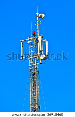 antenna communications tower against a background of blue sky cellular operator of the high metal repeater