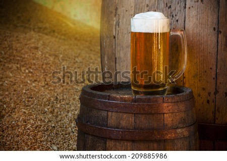 Beer barrel with beer glasses on a wooden table. The dark