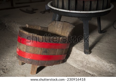 Wine press isolated on white background. Traditional old technique of wine-making.