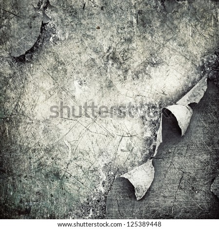 ripped  metal plate  on scratched wall ; grunge background