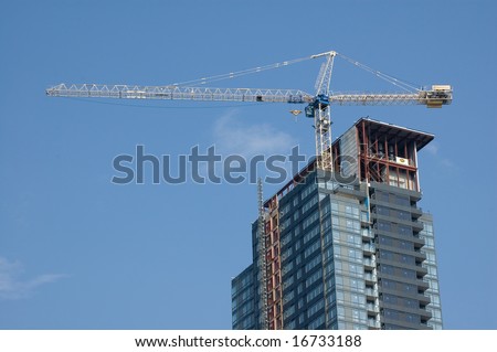 A crain on the top of high-rise building under development