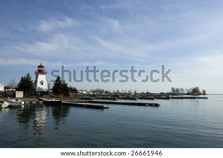 seascape with  light house on the background /  toronto\'s  yacht club with blue sky