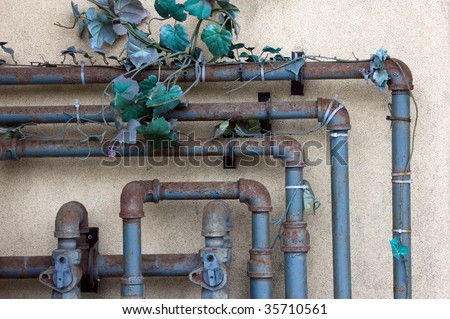 plumbing pipes on  rough wall / abstract grungy background