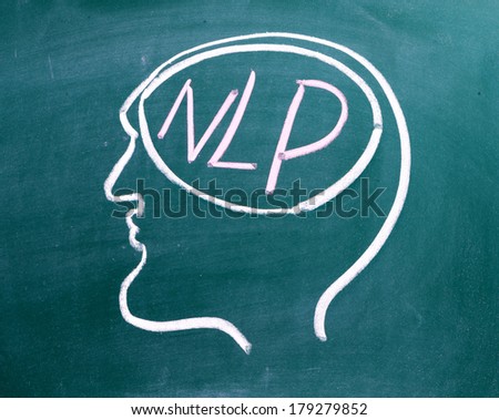 Drawing on a blackboard of a human head in profile with NLP on the brain. NLP is the acronym for Neuro-Linguistics Programming, often used in business and Psychotherapy for self improvement.