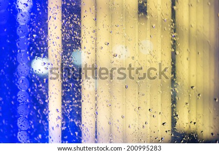 Wet the window with the background of the night city