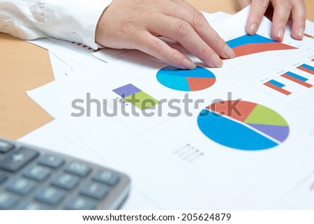 business, office, tax, school and education concept - woman hands with charts and papers