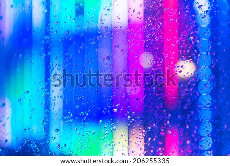 Wet the window with the background of the night city