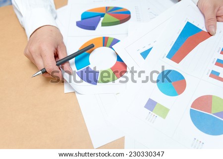 business, office, tax, school and education concept - woman hands with charts and papers