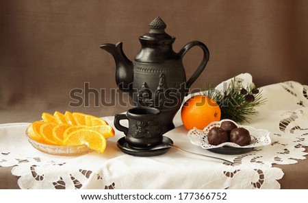 Still life with oranges, sweets and coffee service