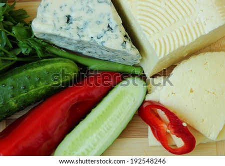 Cheese, homemade cheese and vegetables, top view