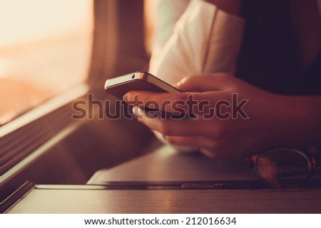 young girl works on the phone on the internet and goes to the train