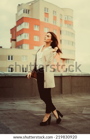 young girl posing in the street with cloak