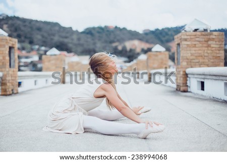 beautiful young girl poses in ballet flats on the pier