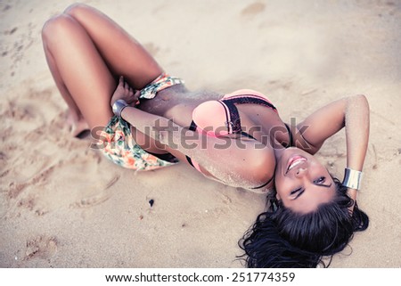 beautiful girl posing in a swimsuit on the beach