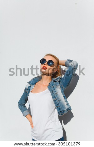 Close up summer fashion portrait of beautiful young sexy woman posing on the streets wear denim jacket,wearing summer trendy sunglasses,natural amazing long hairs and perfect glowing skin.tonned,