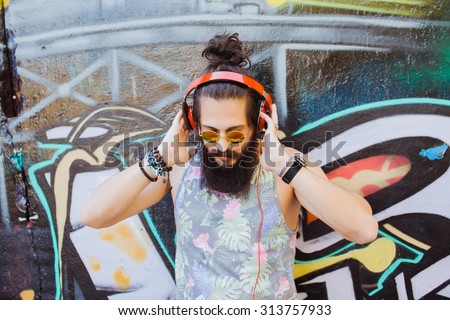 Bearded man,lifestyle portrait of hipster man,cool beard.Mans hairstyle.haircut,hairdresser.Stylish man posing with cool hairstyle,wall,ready to car trip.Happy  active,NYC,California,east coast.Hiker