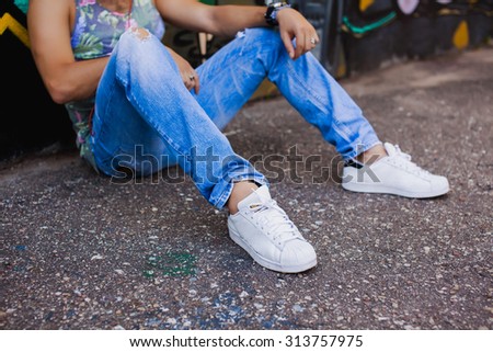 Lifestyle object of trendy mans sneakers,jeans,b-boy,trendy man.Relaxing in a meadow in the summer sun.Mans fashion objects,chilling time,relaxing time.Concept of new mixed with a retro lifestyle