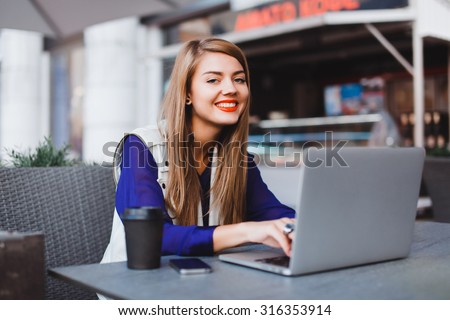 Laptop woman happy giving thumbs up success sign sitting at computer PC with excited face expression. Beautiful smiling cheerful hipster student girl on urban city background.working hard