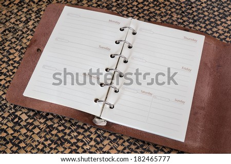 note book paper with pen on mat background