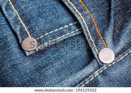 two metal button on jeans close up