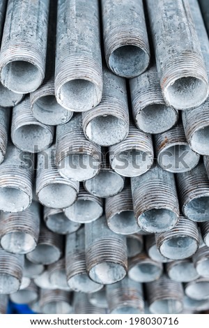 Close up group of stack of iron pipes in an iron shop