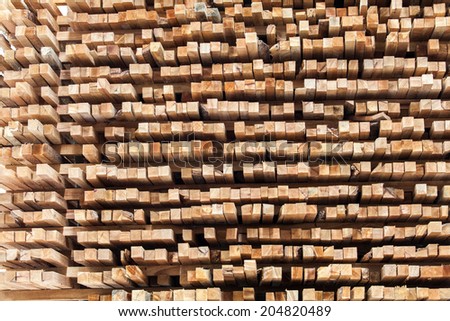 stack of wood logs for background in Lumber mill.