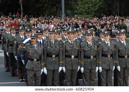 BELGRADE - SEPTEMBER 11h:Promotion of new Serbian army officers,Girl cadet unit singing Serbian anthem,September 11, 2010 in Belgrade, Serbia