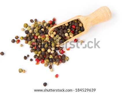 Wooden scoop with pile of pepper isolated on white