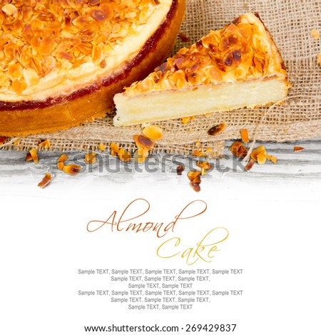 Photo of sliced almond cake on wooden board with white space for text