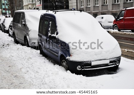 Cars under snow. Parked cars under snow.