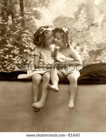 stock photo A vintage photograph c 1900 of two little girls cheek