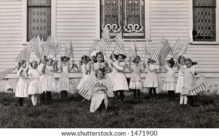 Little girls waving their American Flags in front of a church (stained glass windows) -  a circa 1915 vintage photograph