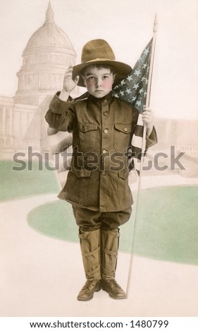 \'\'Your Country Needs You\'\' - Little boy in WWI patriotic dress (as an army \'\'Dough Boy\'\' soldier), with American flag and U.S. Capitol in background - a circa 1917 vintage photograph