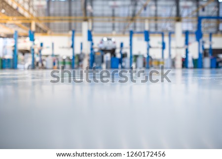 epoxy floor in interior car-care center. The electric lift for cars in the service