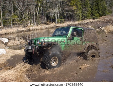 KINGSTON, NOVA SCOTIA, CANADA, APRIL 17, 2008:  A Jeep blasts through a mud bog without getting stuck.