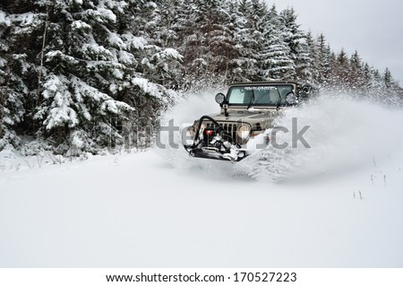 SPRINGHILL, NOVA SCOTIA, CANADA - NOVEMBER 24, 2011 - A Jeep blasts through the snow after the first major snowfall of the season.