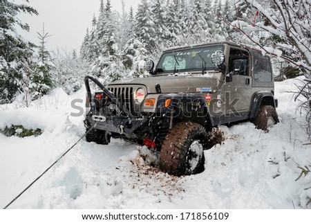 SPRINGHILL, NOVA SCOTIA - JANUARY 9, 2011 - Jeep stuck in snow uses winch for self-recovery.
