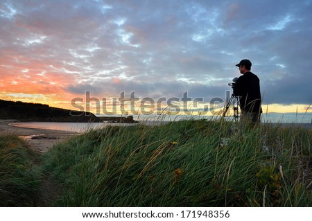 Videographer shoots the setting sun in Margaree Harbor, Nova Scotia